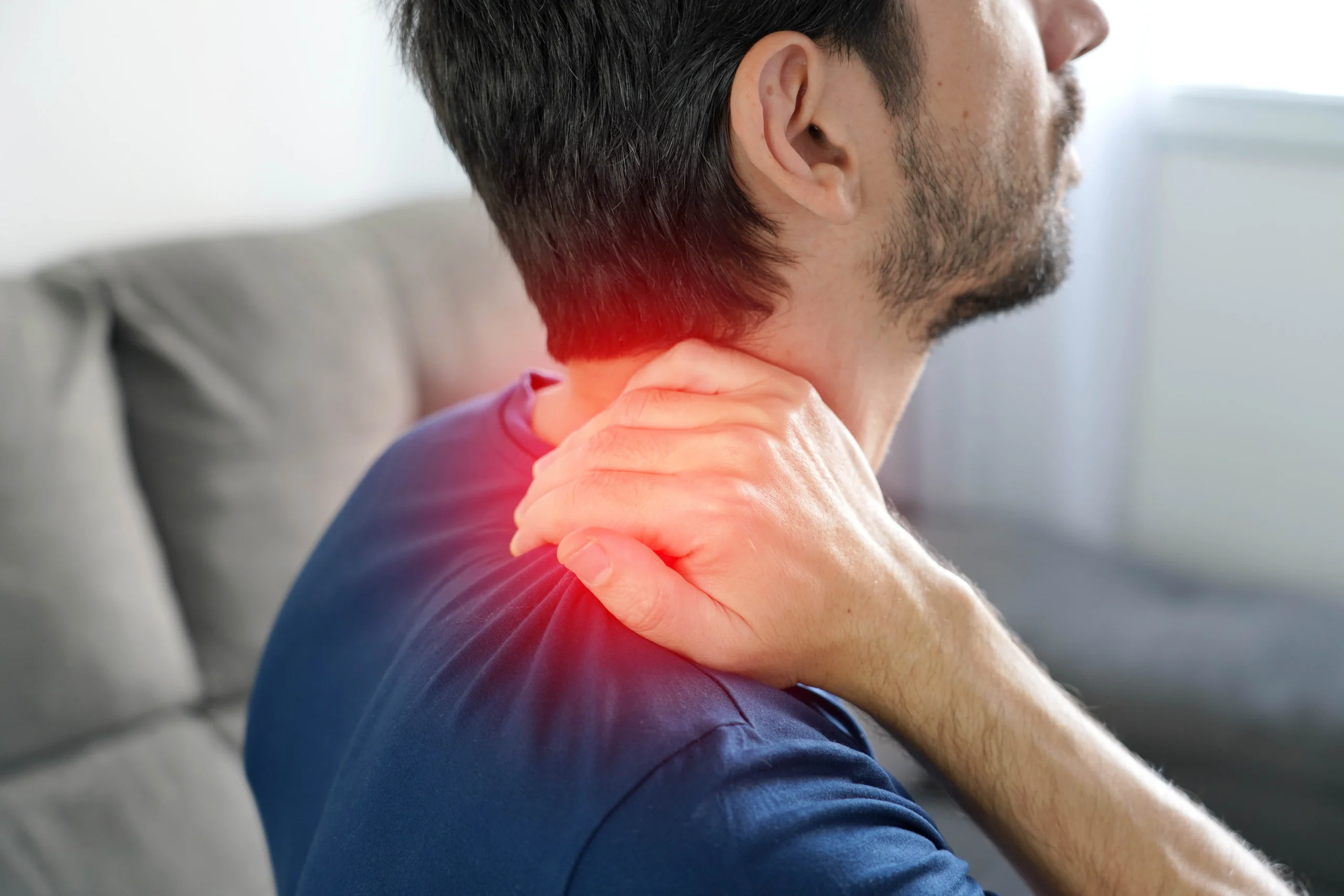 Close-up of a hand gripping the back of the neck